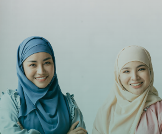 Two sisters in hijab smiling